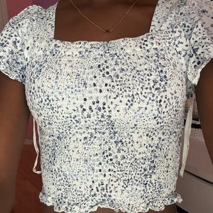 white and blue floral blouse with square neckline